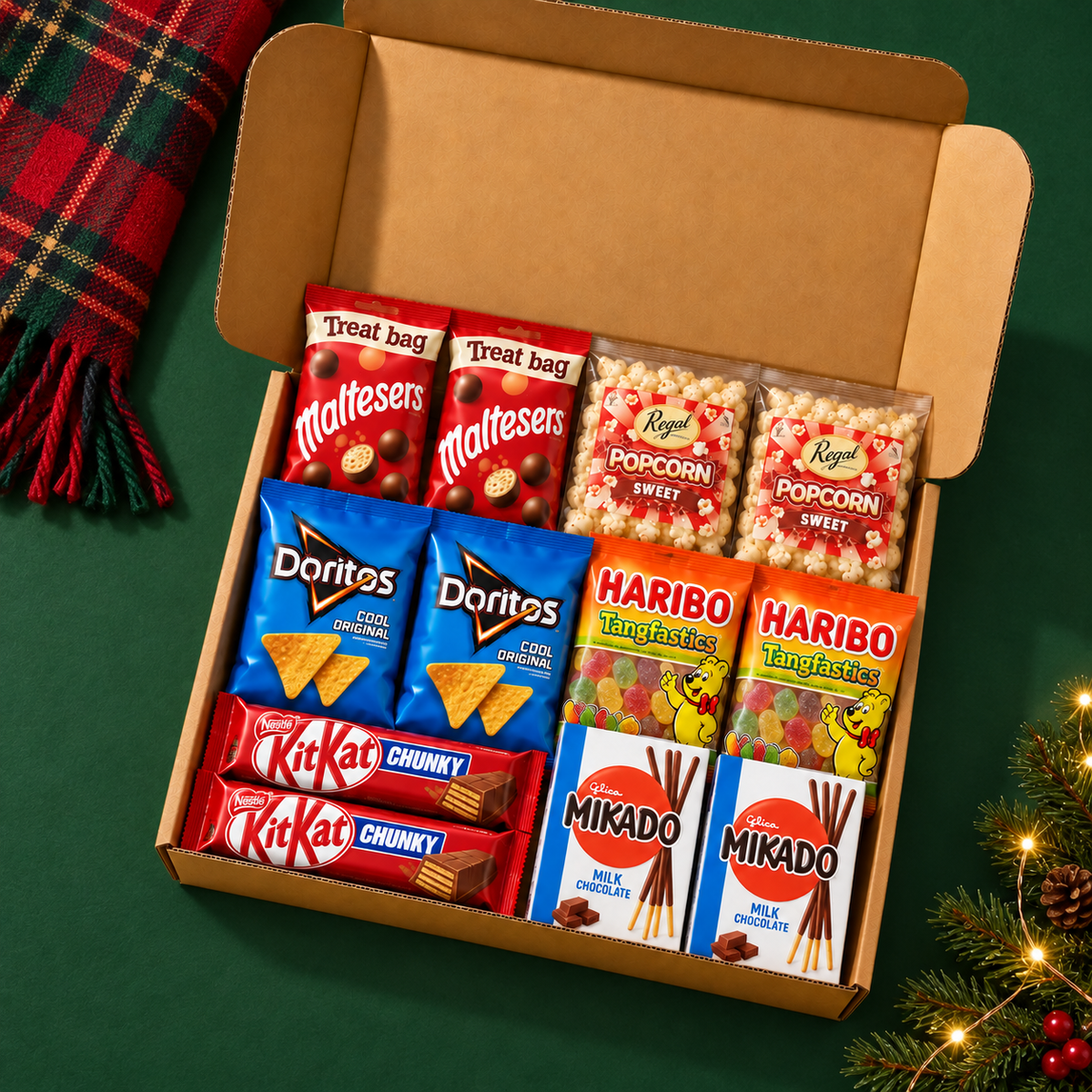 Christmas Movie Night for Two with six pairs of sealed snacks on a cosy green tabletop