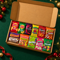 Christmas Sweet vs Savoury Challenge Box with 12 sealed packs on an emerald tabletop
