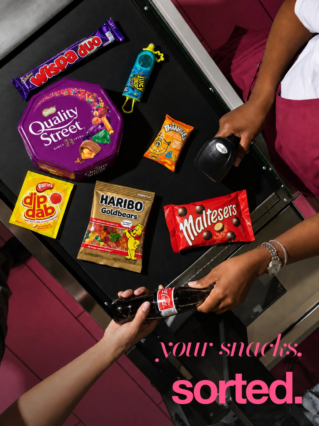 Your snacks, sorted: flash photograph of assorted packaged snacks at a pink checkout. Illustrative selection; contents vary.